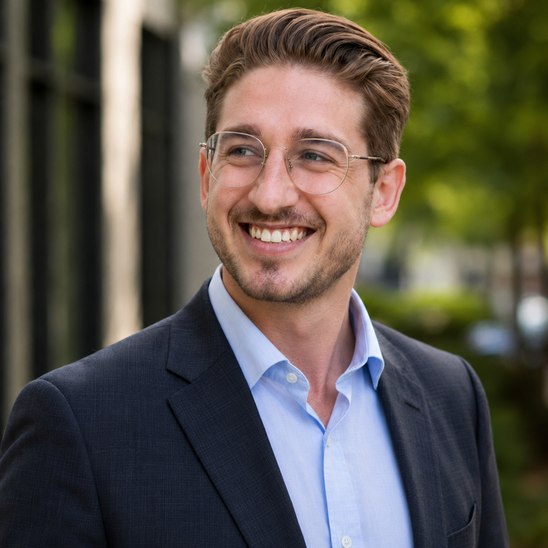 Jacob Suski Jacob Suski professional headshot with trees and buildings in the background.
